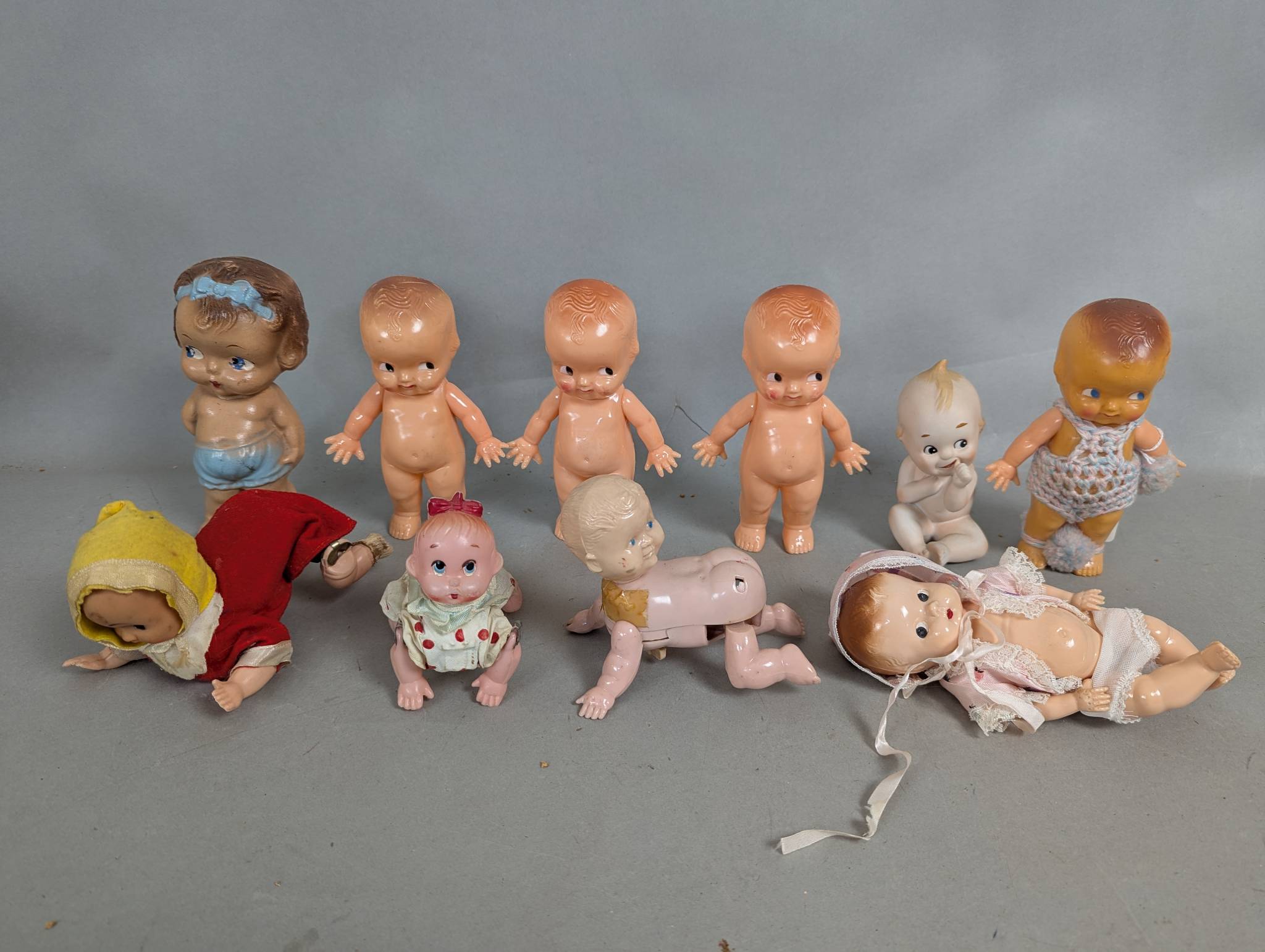 10 Vintage Baby Dolls Made of Hard Plastic with Wind Up Mechanisms