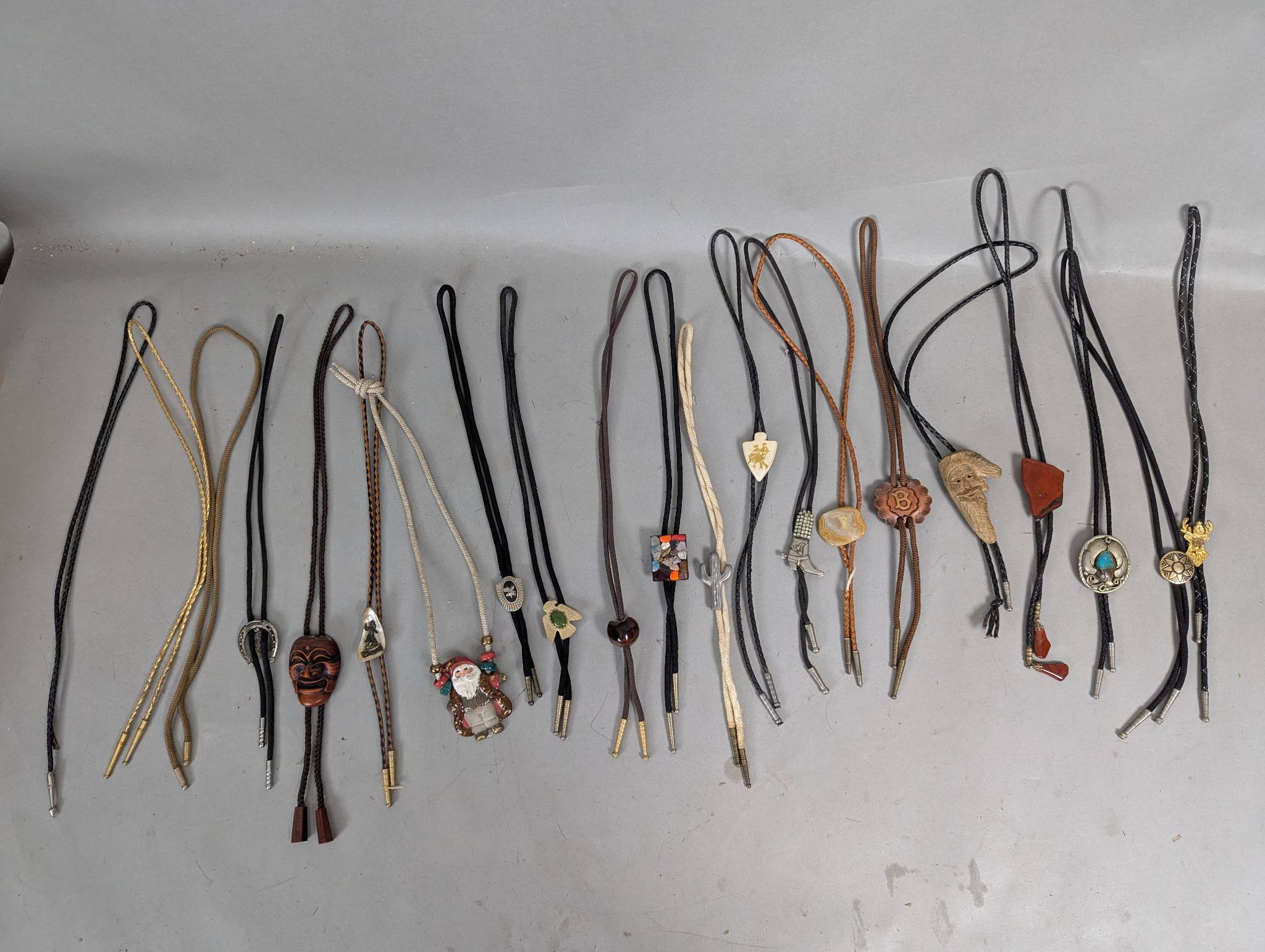 21 Bolo Ties with Various Decorative Slides