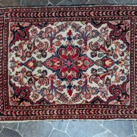 Handwoven Oriental Rug with Red and Floral Motifs